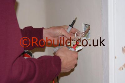 electrician repairing a switch light