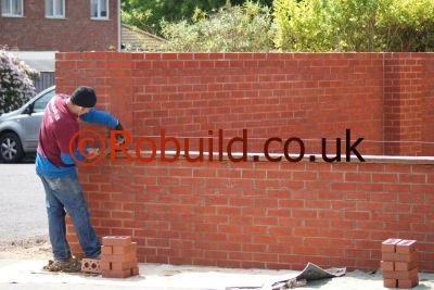 bricklayer building a brickwall 