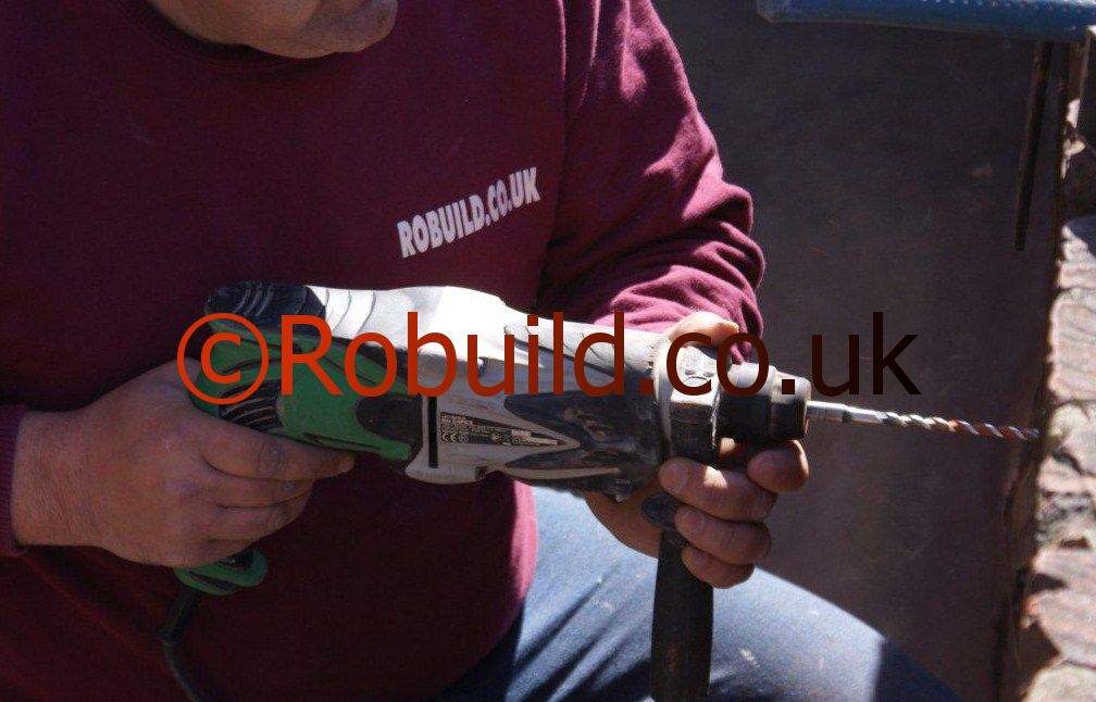 builder using power tool drill